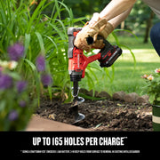 Photo of CRAFTSMAN CMCA320C1 garden auger in use, drilling soil in a garden with plants visible.