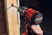 Photo of Craftsman cordless drill CMCD732D2 in use, red and black, drilling into wood, side angle.