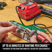 Photo of Craftsman CMCE040B cordless soldering iron in use on a circuit board, Craftsman V20 battery in background.