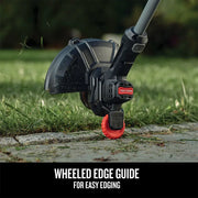 Photo of Craftsman grass trimmer with red wheeled edge guide, model CMCK279C2, trimming lawn edge.