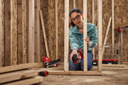 Photo of Craftsman cordless nailer CMCN150B used on a wooden frame, indoor construction setting.