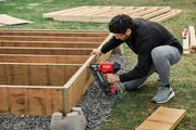 Photo of Craftsman CMCN630PTB framing nailer used for wood construction outdoors.
