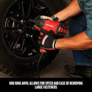 Photo of Craftsman impact wrench CMEE100 used on a vehicle wheel by a person wearing Craftsman gloves.