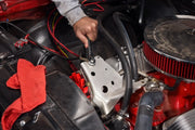 Photo of a hand using a CRAFTSMAN ratcheting wrench, SKU CMMT87220, tightening a bolt on a car engine.