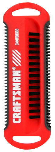 A red and black handheld cleaning brush with the brand name 'CRAFTSMAN' printed on it. The brush has two handles, black bristles, and a compact rectangular design.
