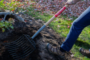 Photo of CRAFTSMAN garden fork CMXMLTP35326 with wood handle in use on soil outdoors.