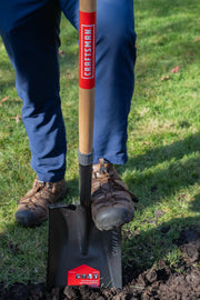 Photo of Craftsman shovel SKU CMXMLTP35330 with wood handle and steel blade in use on grass.