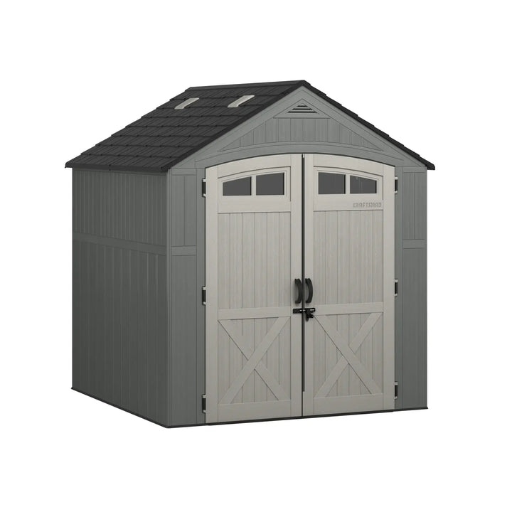 Craftsman CMXRCSCBMSC7752 storage shed with double doors, windows, and gray panels, front angle on white background.