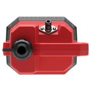 Close-up view of a red rectangular device with a black round connector and a silver mounting point, photographed from the top. The device has a handle and angular edges, likely a piece of electronic or photography equipment.