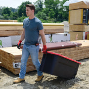 Photo of a person pulling a Craftsman rolling storage bin with red lid, SKU CMXXPBP50GTW, at a lumber yard.