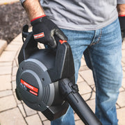 Photo of Craftsman retractable blower, SKU CMXZVBE38640, being held by a person wearing Craftsman gloves outdoors.