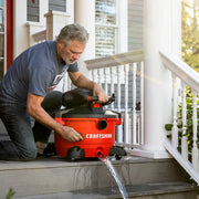 Photo of Craftsman wet/dry vacuum CMXZVBE38773 draining water on porch steps.